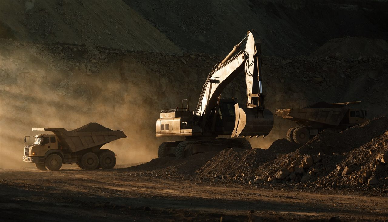 Machinery, the Group's excavator and haul fleet working a pit at golden hour