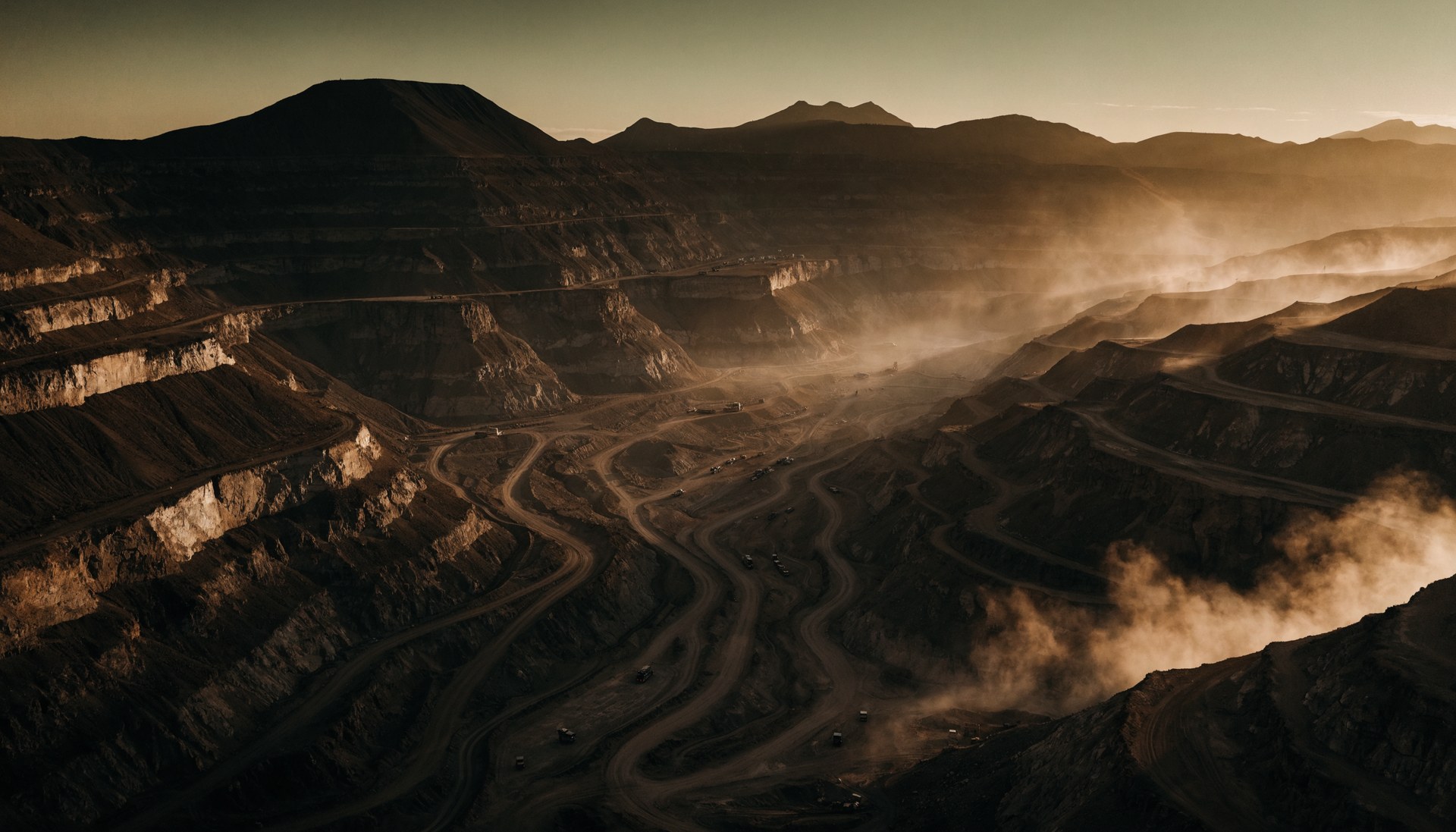 Heavy equipment working an open pit at dusk in sub-Saharan Africa